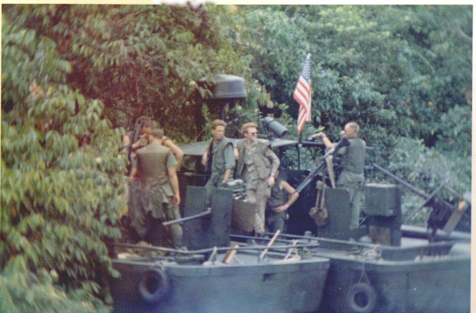 Stay on the boat is on a Dong tributary close to Go Du Ha, Wayn Frobes is the guy left center looking away from bank.
